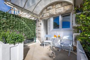 a patio with two chairs and a table at Val Apartments in Dubrovnik