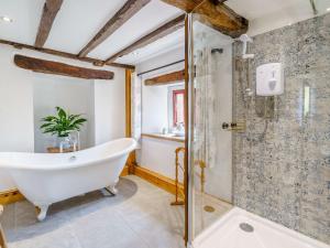 a bathroom with a bath tub and a shower at 2 Bed in Ulverston 83453 in Great Urswick