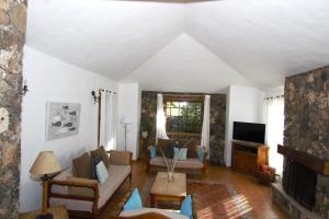 a living room with a couch and a fireplace at Villa Los Morales-Roque in Cotillo