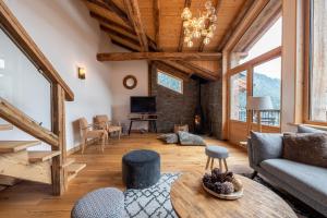 a living room with a couch and a table at Chalet Alouette in Champagny-en-Vanoise