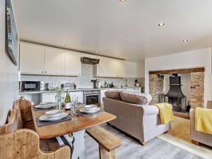 a kitchen and living room with a couch and a table at 2 bed in Dartmoor National Park WAYTO in Ashbury