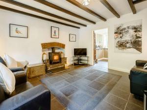 a living room with a couch and a fireplace at 2 Bed in Aberporth 85444 in Felindre