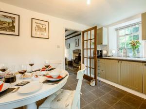 a kitchen and dining room with a table with wine glasses at 2 Bed in Aberporth 85444 in Felindre