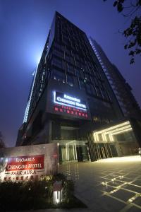 a tall building with a sign in front of it at Rhombus Park Aura Chengdu Hotel in Chengdu