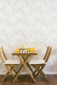 a table with two chairs with food on it at Golden Stay - B&B Experience in Albufeira