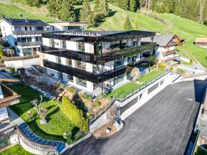 an aerial view of a mansion with a large building at Timeless Dolomites Apartments in Dobbiaco