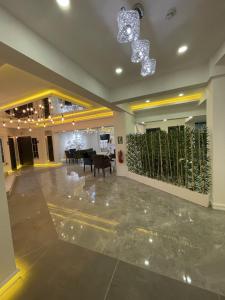 a lobby with a table and chairs and a chandelier at Mi Hotel Boutique in Antalya