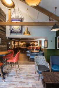 a restaurant with chairs and tables in a room at Dartmoor Halfway Campsite in Newton Abbot