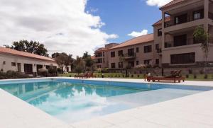 a swimming pool in front of a building at Cafayate Buenas Vides in Cafayate