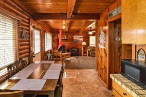 a dining room with a table and chairs in a cabin at Harris Lakeview Cabin in Bass Lake