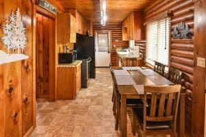 a kitchen with a table and chairs in a cabin at Harris Lakeview Cabin in Bass Lake