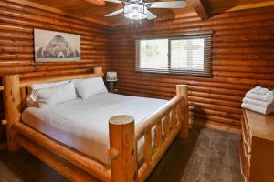 a bedroom with a bed in a log cabin at Harris Lakeview Cabin in Bass Lake