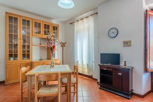 a dining room with a table and a tv at Casa dei Pini Pieve a Nievole in Pieve a Nievole