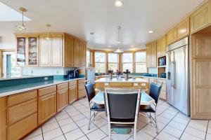 a kitchen with wooden cabinets and a table and chairs at Anchors Aweigh in Rockaway Beach