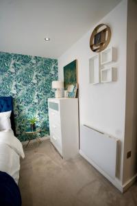 盧頓的住宿－Luxury 2 Bed Apartment in Town Centre - FREE WIFI!!，卧室配有白色梳妆台和蓝白色墙壁。