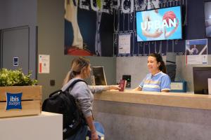 two women standing at a counter in a coffee shop at Ibis Budget Bilbao City in Bilbao