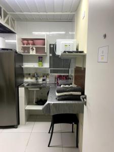 a kitchen with a sink and a refrigerator at 44 LOFT DUPLO · LOFT perto do São Paulo Expo e c estacionamento in Sao Paulo