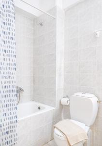 biała łazienka z toaletą i wanną w obiekcie Ostria Studios w Retimnie