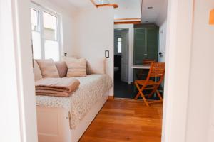 a living room with a couch and a table at Ilsehof Tiny-House Mimi in Osterwieck +24 photos