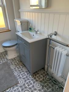 a bathroom with a sink and a toilet at Rose Cottage in Lustleigh +43 photos