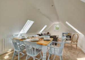 a dining room with a table and four chairs at Primrose Cottages in Roughton