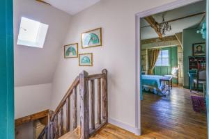 a hallway with a staircase and a living room at Maison de charme en Touraine avec jardin 4 p. in Luynes