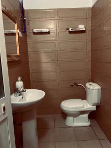 a bathroom with a toilet and a sink at Poga Apartment in Durrës