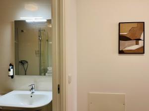a bathroom with a sink and a mirror at Casa da Moeda by Escapadinha Portuguesa in Coimbra