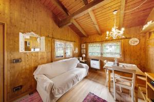 a living room with a white couch and a table at Orserose Chalet 3 I Ciodi in Forno di Zoldo