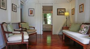 a living room with two chairs and a couch at The Hermitage Inn in Charlestown