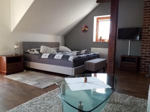 a bedroom with a bed and a glass table at Green Apartment in Františkovy Lázně