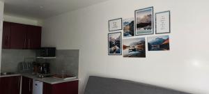 a kitchen with pictures hanging on the wall at Le Serre in Belvédère