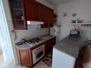 eine kleine Küche mit einem Herd und einem Kühlschrank in der Unterkunft Piccione Marittimo Casa Vacanze in Livorno