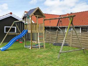 a playground with a slide and a swing at 8 person holiday home in Juelsminde in Sønderby