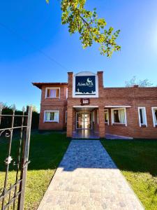 a brick building with a sign on the front at Hotel Aimara in Mina Clavero