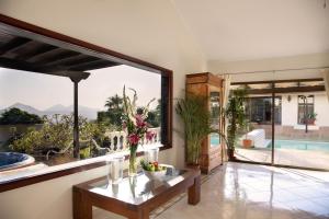 a living room with a table and a large window at Villa Dora Bella in Nazaret