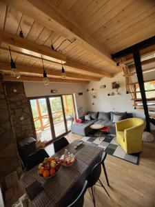 a living room with a table and a couch at Brvnara Tarska Zora in Sekulić 
