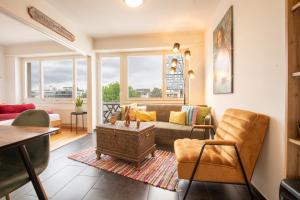 a living room with a couch and a table at Special MODERN LiSA Apartment Basel, Bahnhof Grossbasel 10-STAR in Basel +49 photos