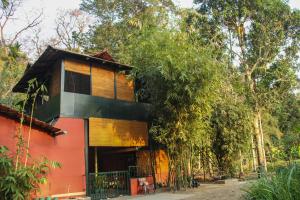 una casa en medio de árboles en Rancho Farmstay, en Sultan Bathery