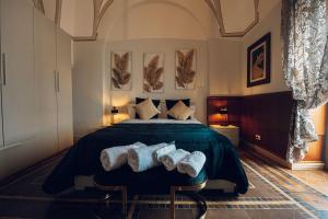 a bedroom with a bed with three pillows on it at Verso Oriente in Brindisi