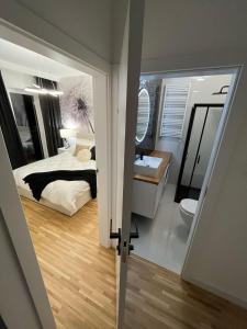 a bedroom with a bed and a sink and a toilet at Apartamenty Cieszyn in Cieszyn