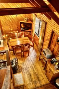 a wooden dining room with a table and chairs at Cabañas Bafemadi in Las Trancas