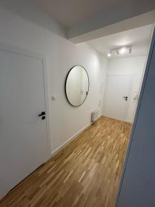 an empty room with a mirror and a wooden floor at Apartamenty Cieszyn in Cieszyn