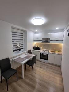 a kitchen and dining room with a table and chairs at Trumpalaike buto nuoma in Rokiškis