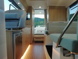 an interior view of an rv with a kitchen and a sink at Koolhouse Boat in Vila Nova de Foz Coa