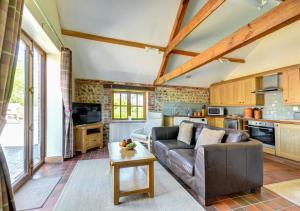 a living room with a couch and a table at Pond Cottage in Sidestrand