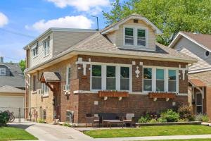 a brick house with a bench in front of it at Norwood Park/Edison Park! Workstation & In-unit Laundry! 2nd Floor Apt in Chicago