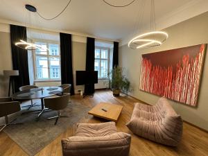 a living room with a table and a dining room at Kaiserin Sissi - City Apartment Downtown Vienna in Vienna