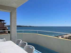 a balcony with a view of the ocean at Apartments Panorama Ravda in Ravda