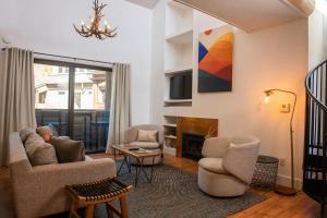 a living room with a couch and chairs and a fireplace at Meadowbrook Condos in Ketchum